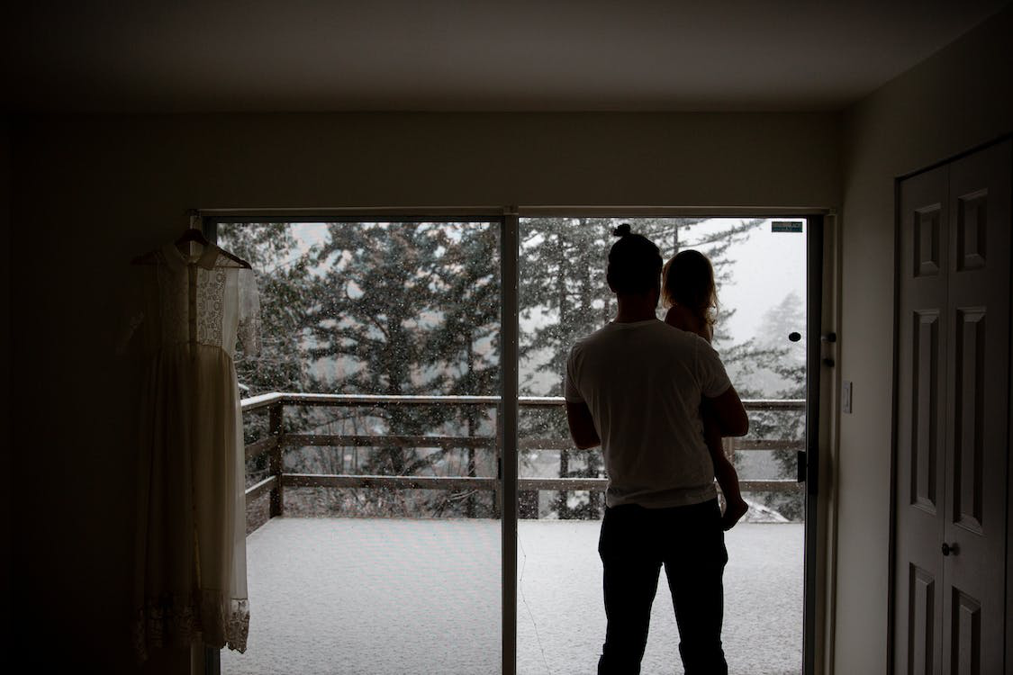 People inside their home while it is snowing outside