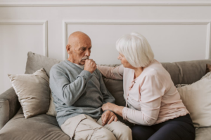 indoor air An image of an elderly couple sitting on a sofa in their home with the man coughing