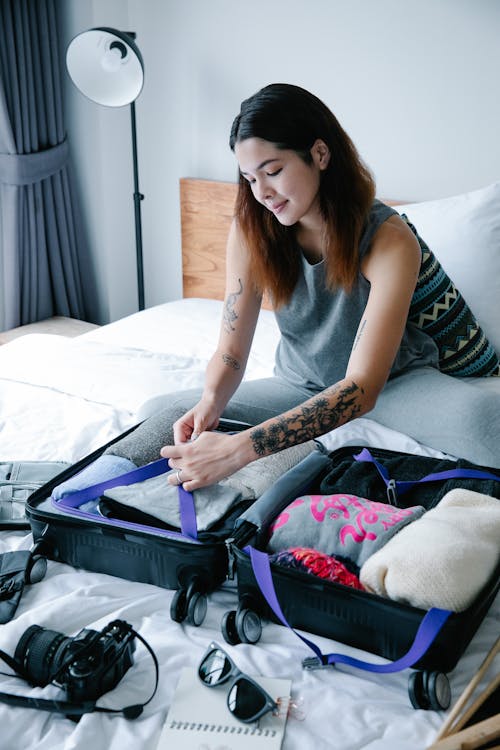 a woman packing her suitcase.